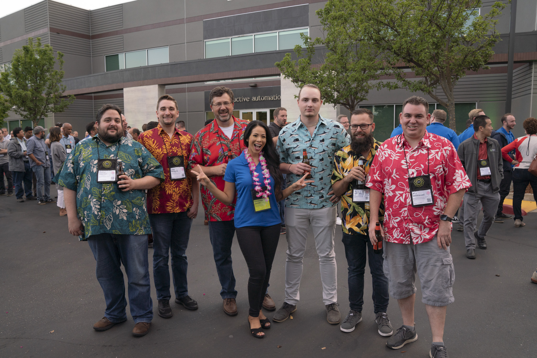 Six Roeslein employees wearing different Hawaiian shirts,  with IA Account Executive Vannessa Garcia standing in front holding up two peace signs